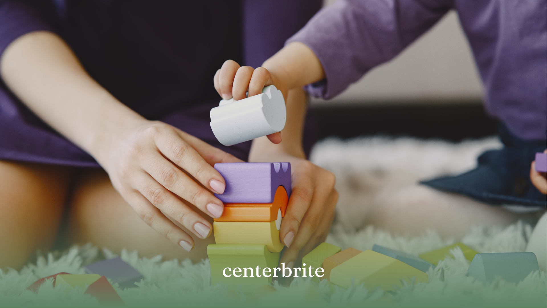 A BCBA and a kid with autism playing building blocks together during ABA therapy